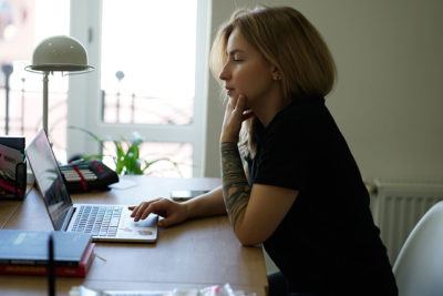 woman sitting in front of laptop