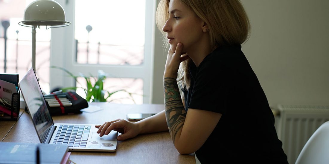 woman sitting in front of laptop