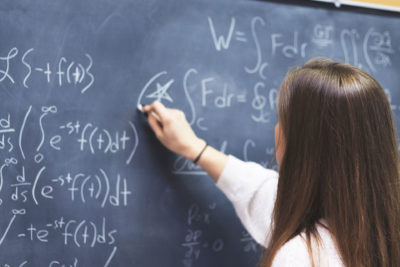 picture of student at blackboard doing math