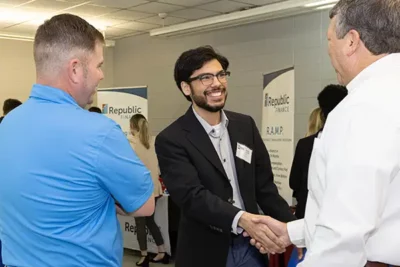 nicholls student shaking hands with human resource professionals