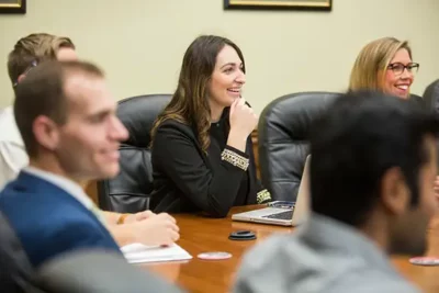 nicholls student in board room meeting