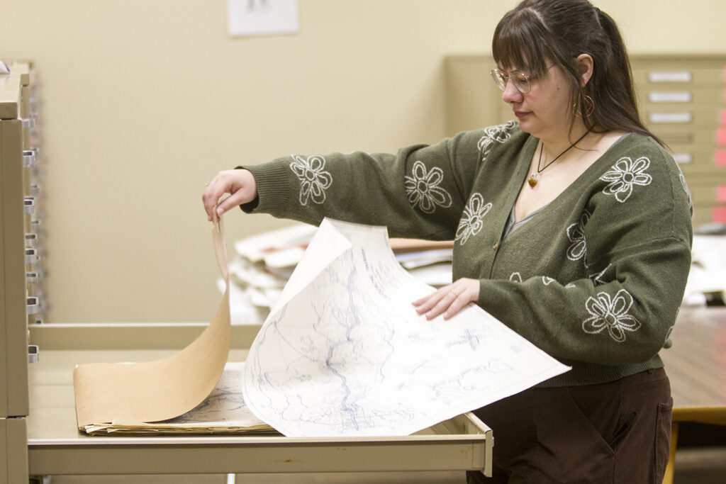 Librarian Jade Hornback reviews a map of Lafourche Parish in the department's map room. The Government Information Department has hundreds of maps.