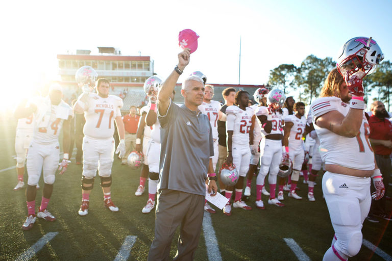 football coach waving hat