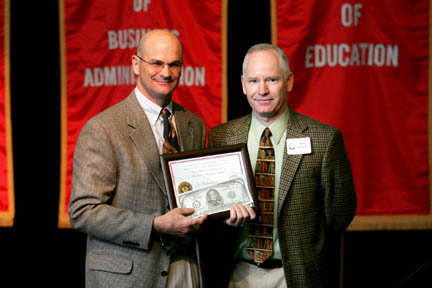 Dr. John Lajaunie, professor of finance and certified master adviser at Nicholls State University, accepts the 2009 Wal-Mart Excellence in Academic Advising Award, presented by Dr. Robert Allen Alexander (right), director of retention and student engagement for University College and associate professor of English.