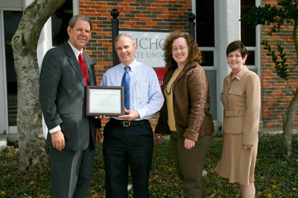 Octave Hymel, program coordinator for the Louisiana Center for Dyslexia and Related Disorders at Nicholls State University, is the Nicholls Academic Council’s February honoree for outstanding and significant contributions to teaching. Pictured from left are Dr. Carroll Falcon, provost and vice president for academic affairs; Hymel; Karen Chauvin, director of the Louisiana Center For Dyslexia and Related Disorders, and Dr. Susan Roark, distinguished service professor of education and acting dean of the College of Education.