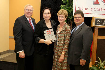 The James Lynn Powell Award, the highest honor awarded to a Nicholls alumnus or alumna, was presented to 1977 graduate Dawn Lafont, principal of Pointe-Aux-Chenes Elementary School in Terrebonne Parish. Pictured from left are Dr. Stephen Hulbert, university president; Lafont; Deborah Raziano, director of alumni affairs; and Brett Terrebonne, president of the Nicholls Alumni Federation.