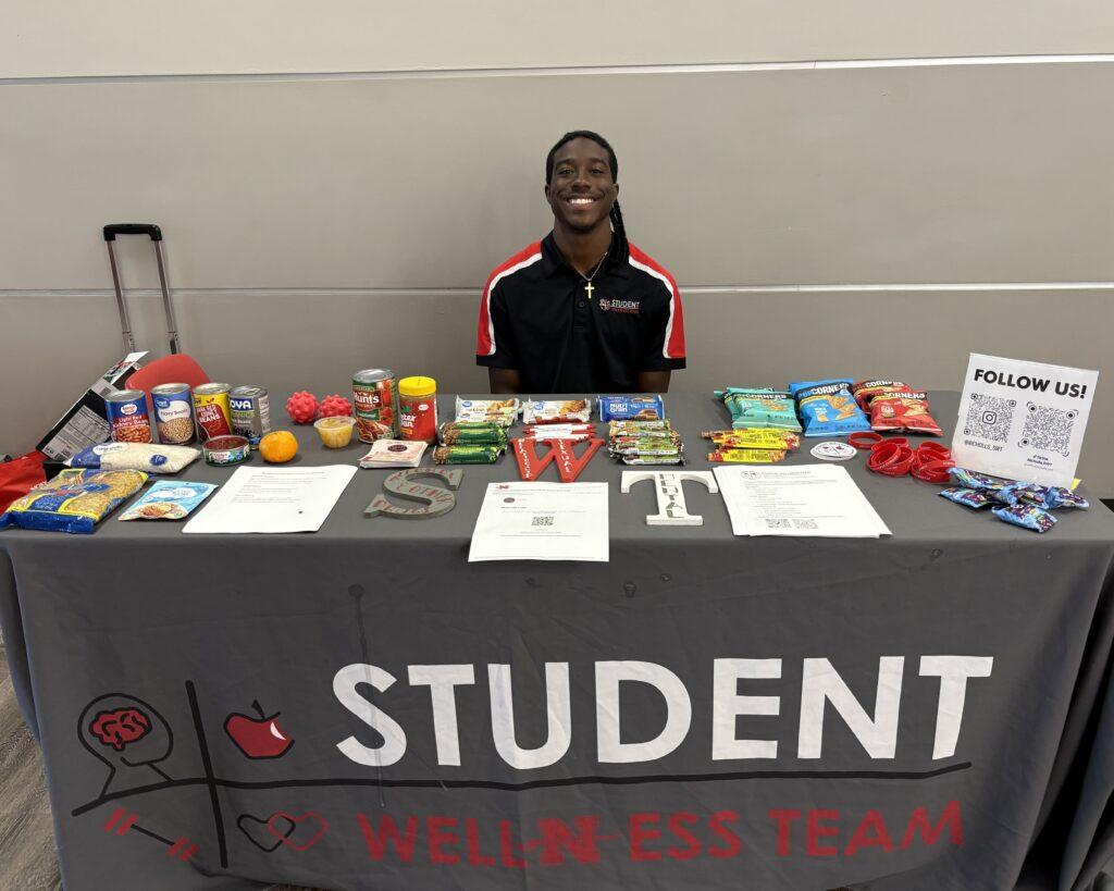 A student sitting at an information table.