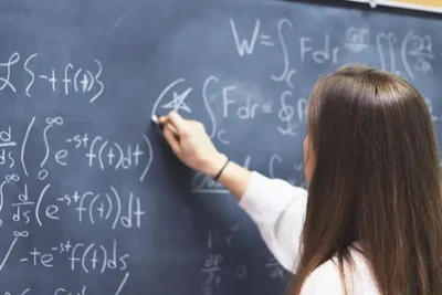 picture of a nicholls student at blackboard doing math