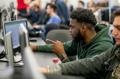 nicholls student pointing at computer